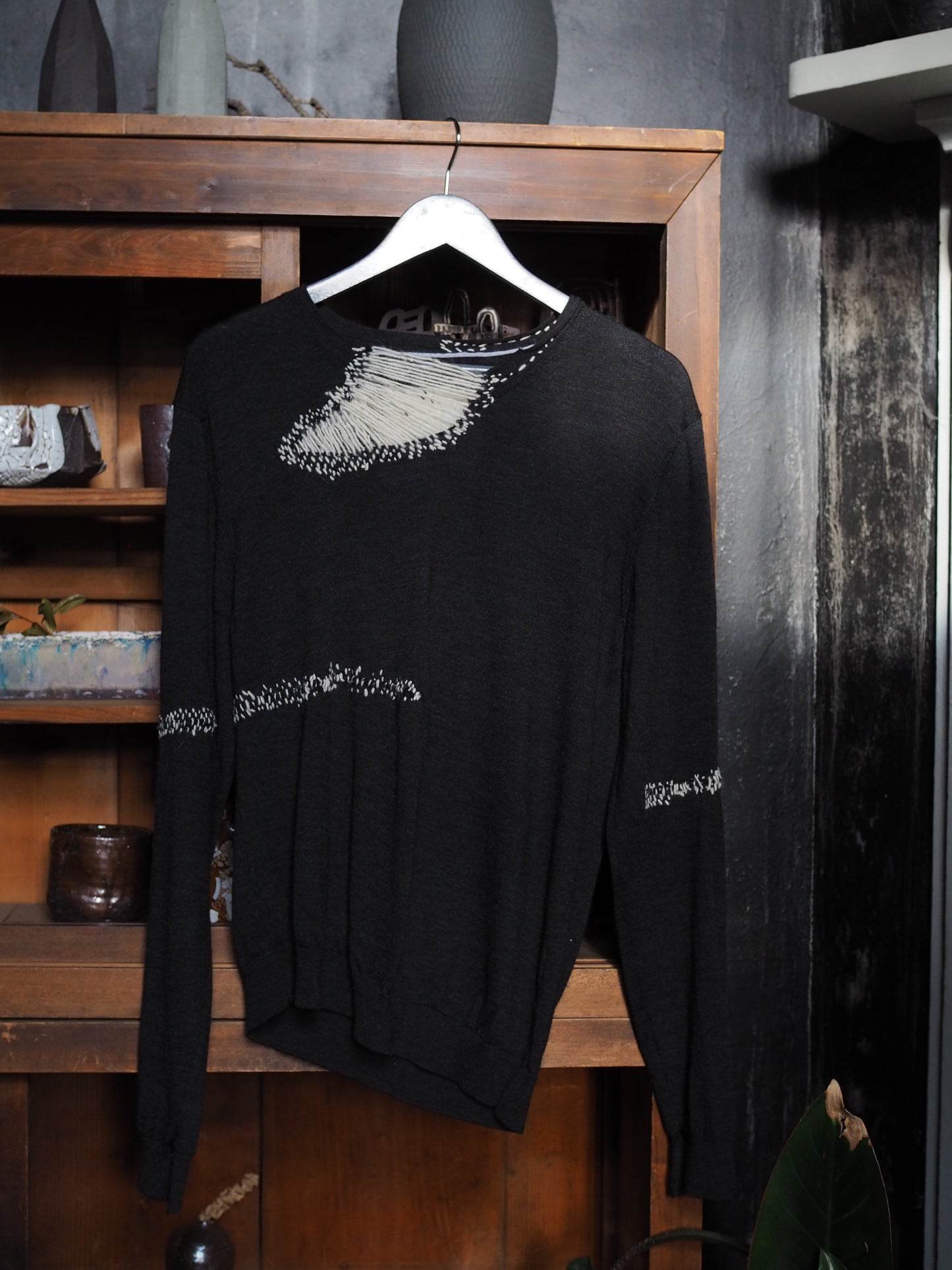 Charcoal merino with white hand-stitching.