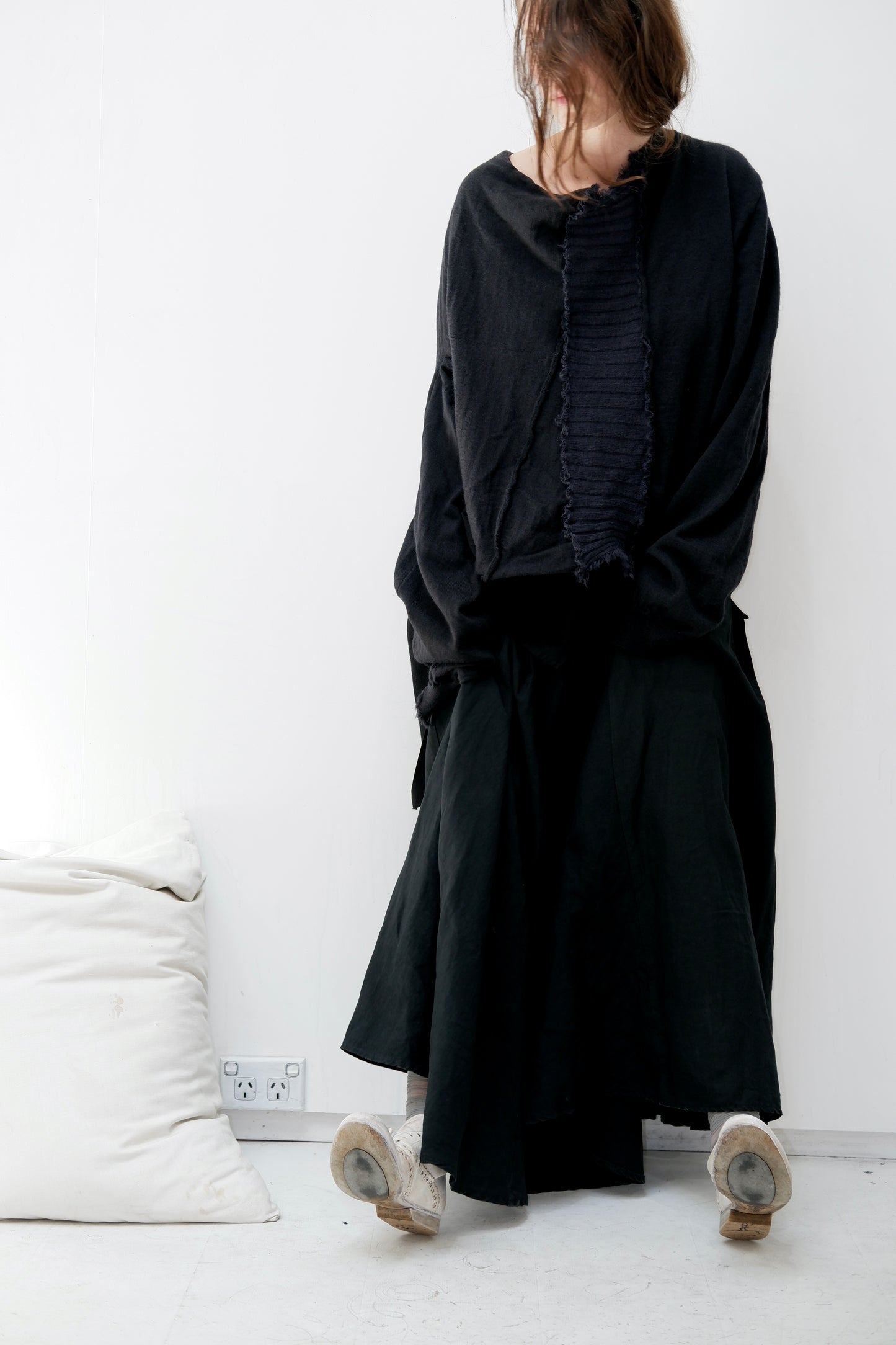Charcoal merino jumper with blue panel at front / Black patched skirt with pleats