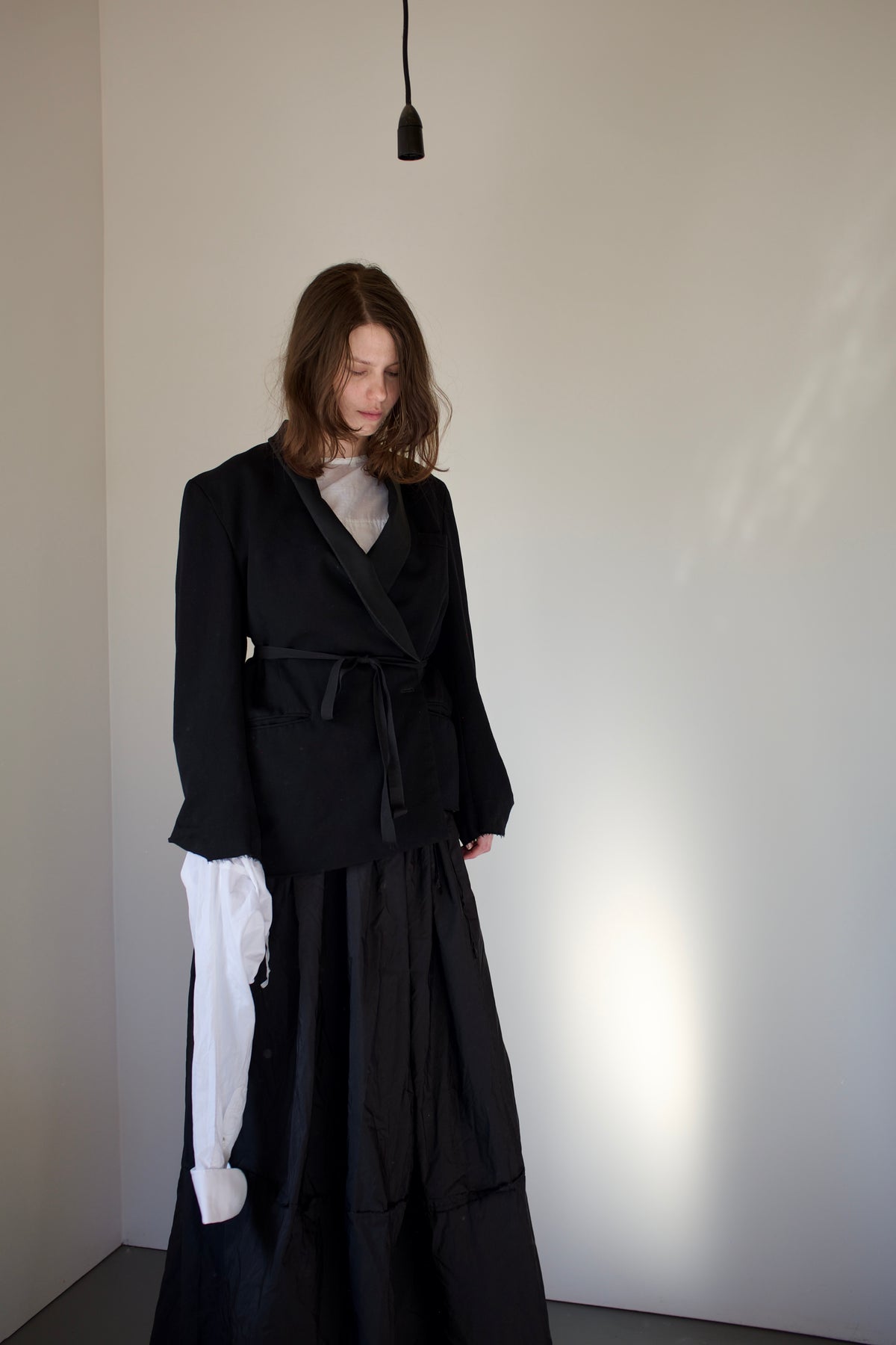 Black asymmetrical dinner jacket with waist ties