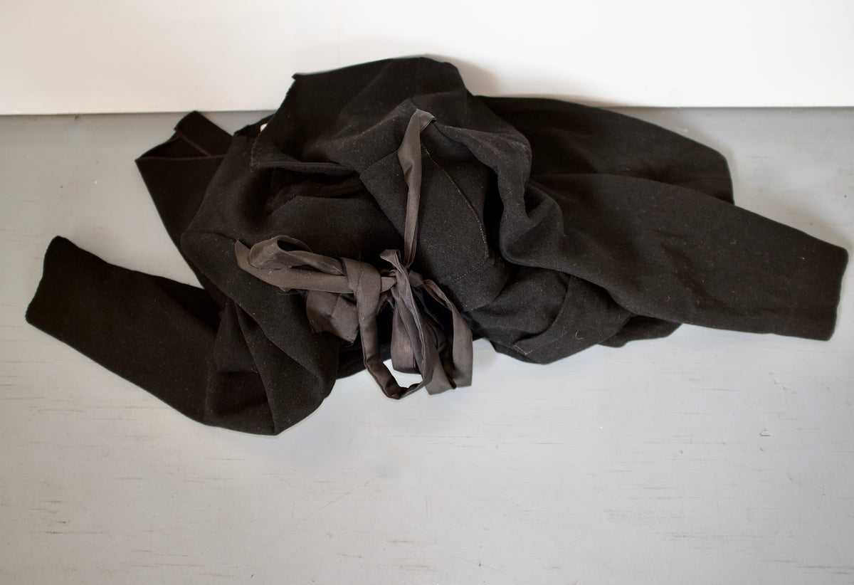 Black wool deconstructed jacket with silk chest tie and hand-stitched lapel