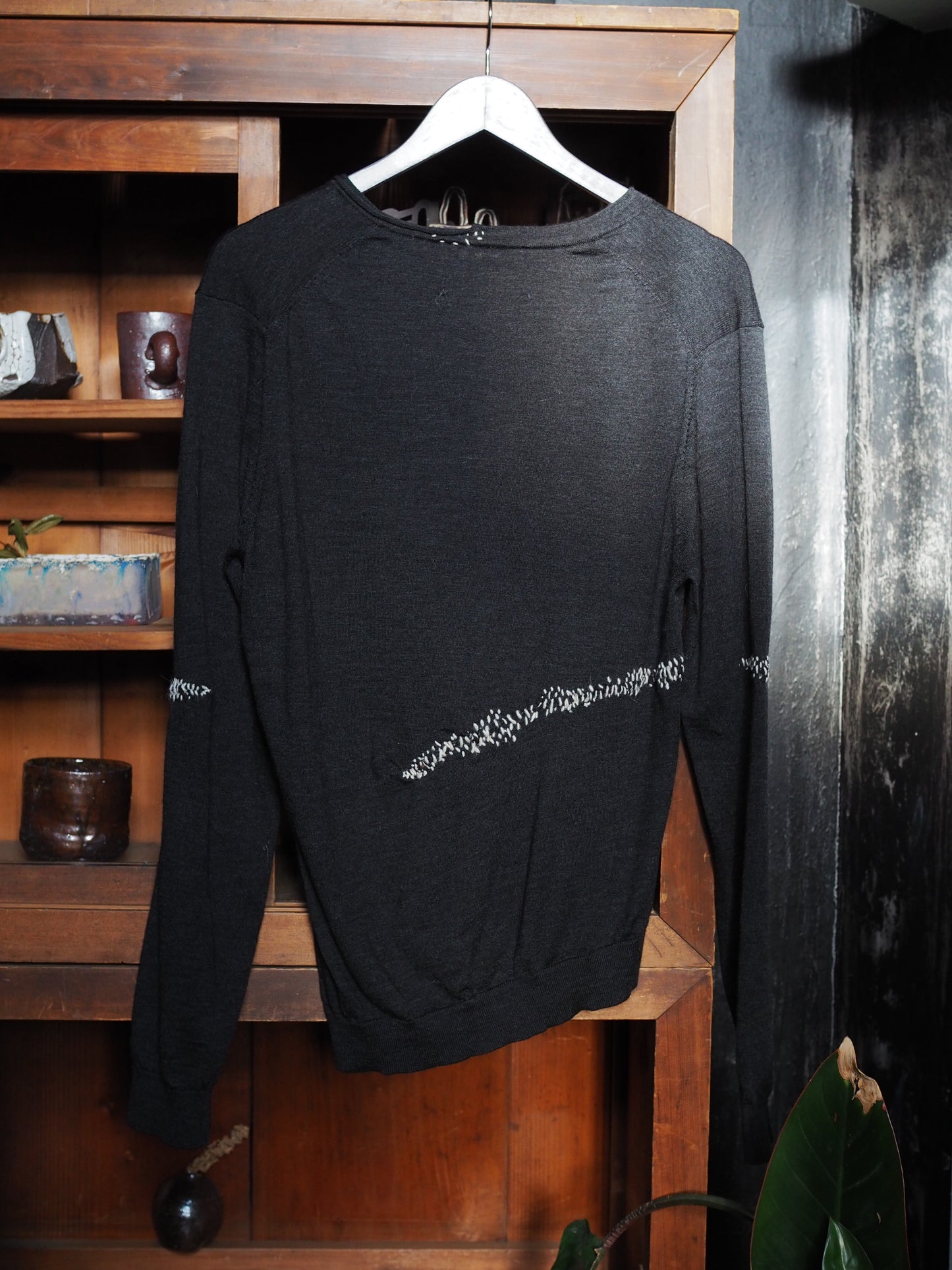 Charcoal merino with white hand-stitching.