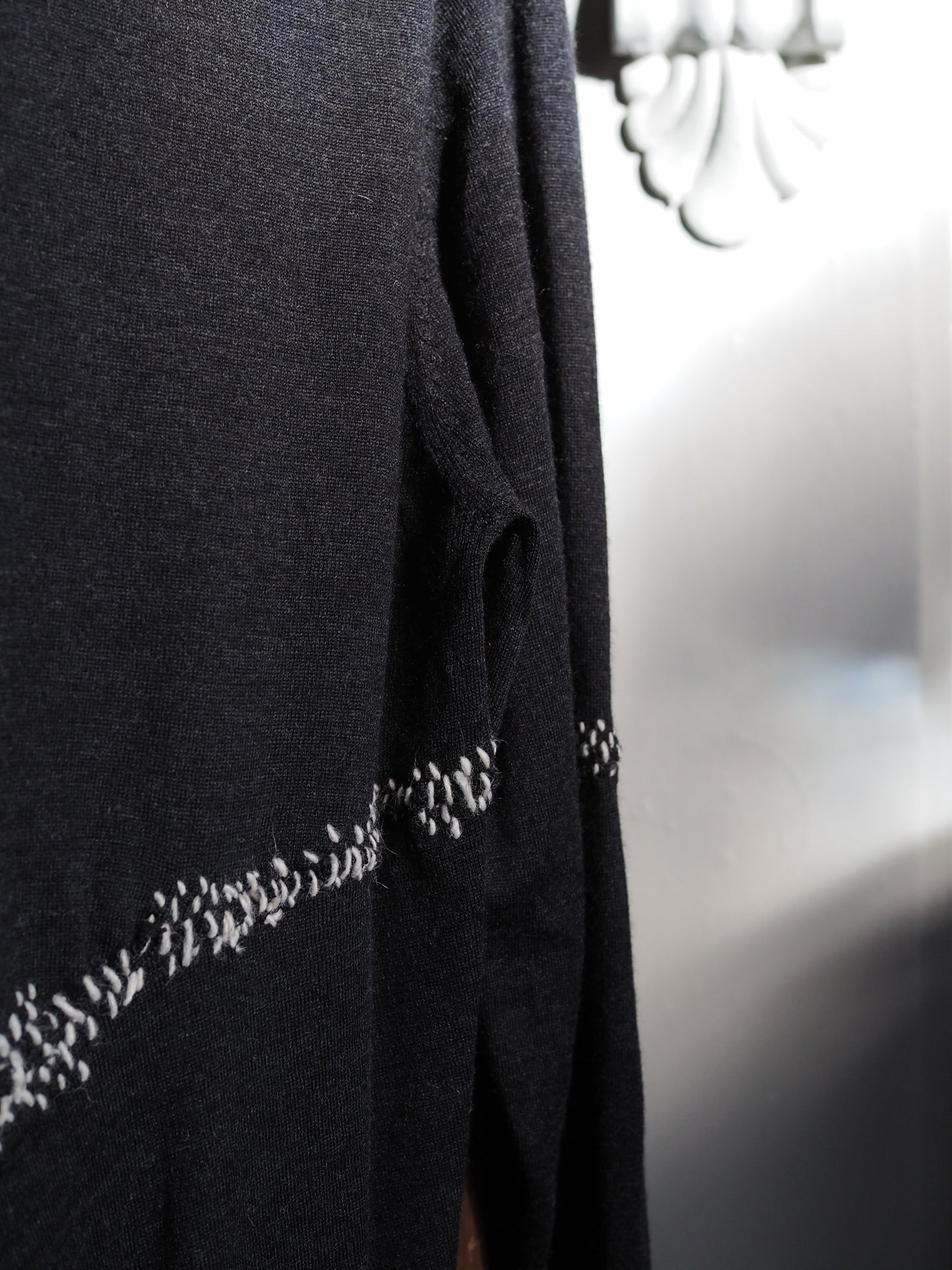 Charcoal merino with white hand-stitching.