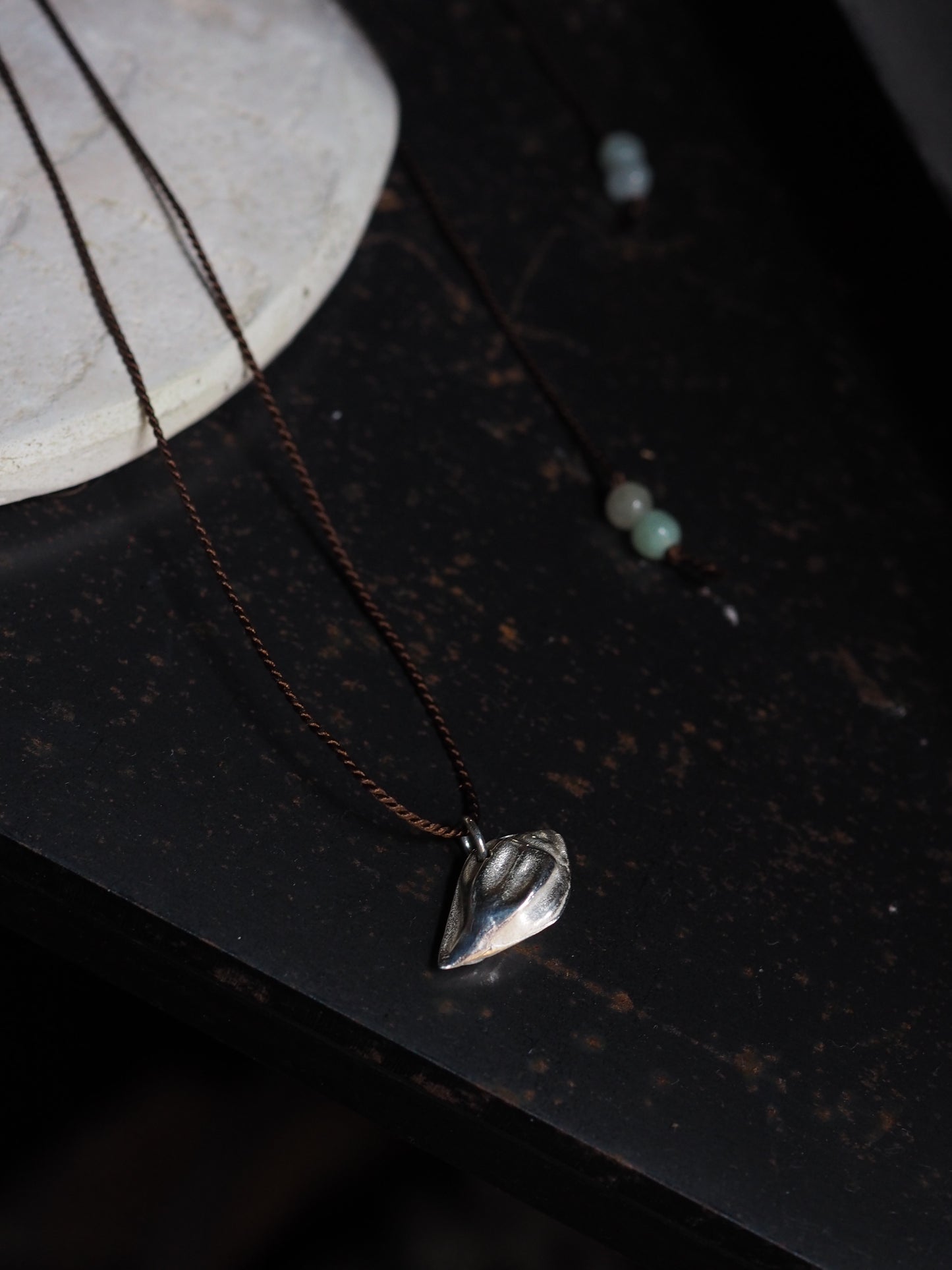 Silver Almond Shell on Brown Silk Necklace