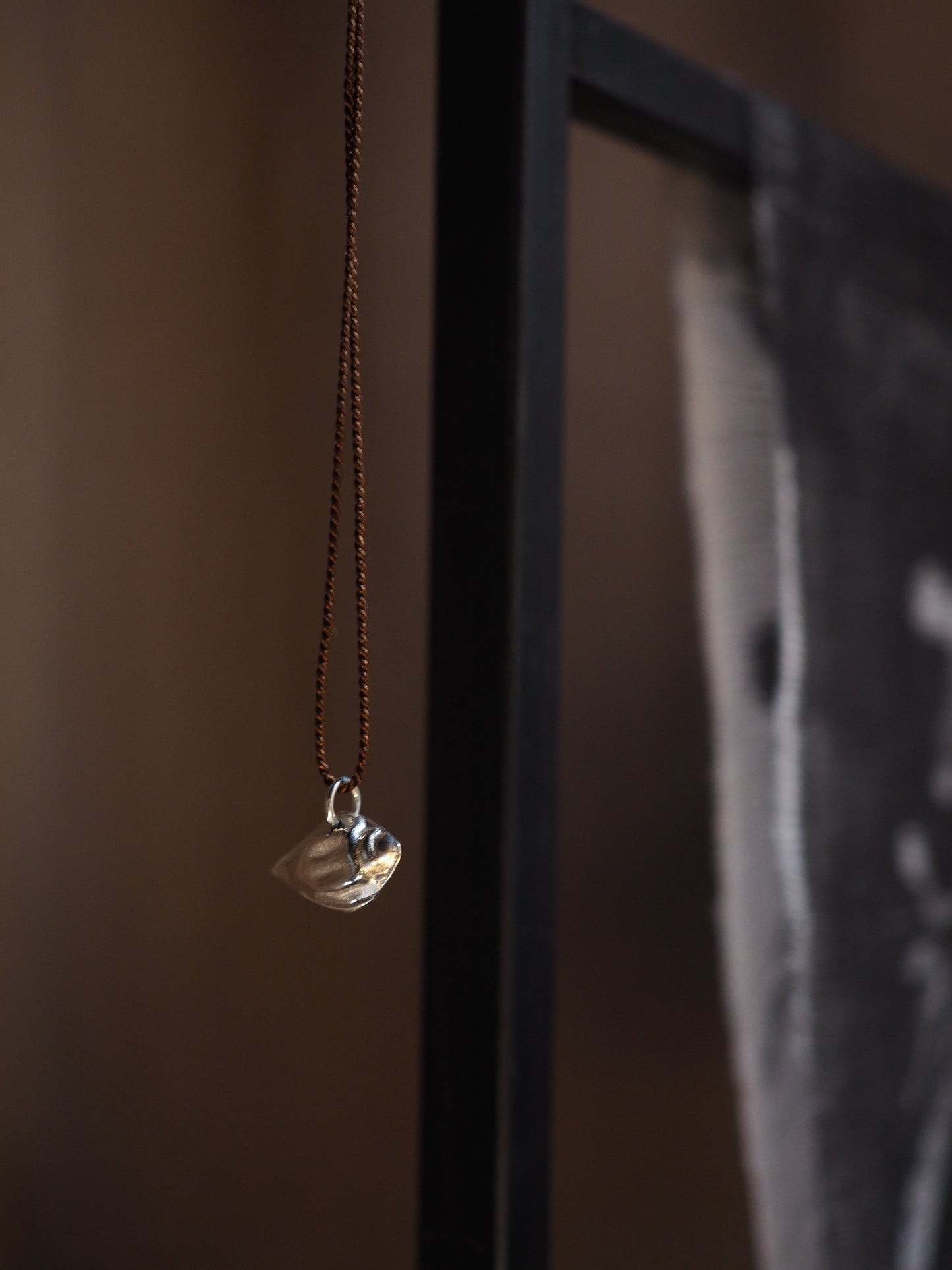 Silver Almond Shell on Brown Silk Necklace