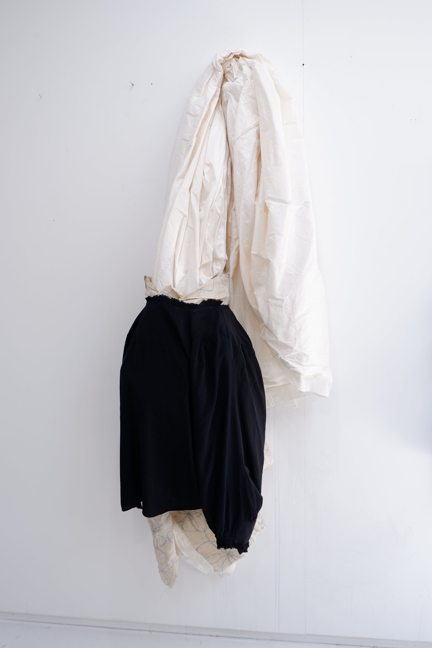 Black ‘2 sides’ long-sleeves top.  W. Hand stitching